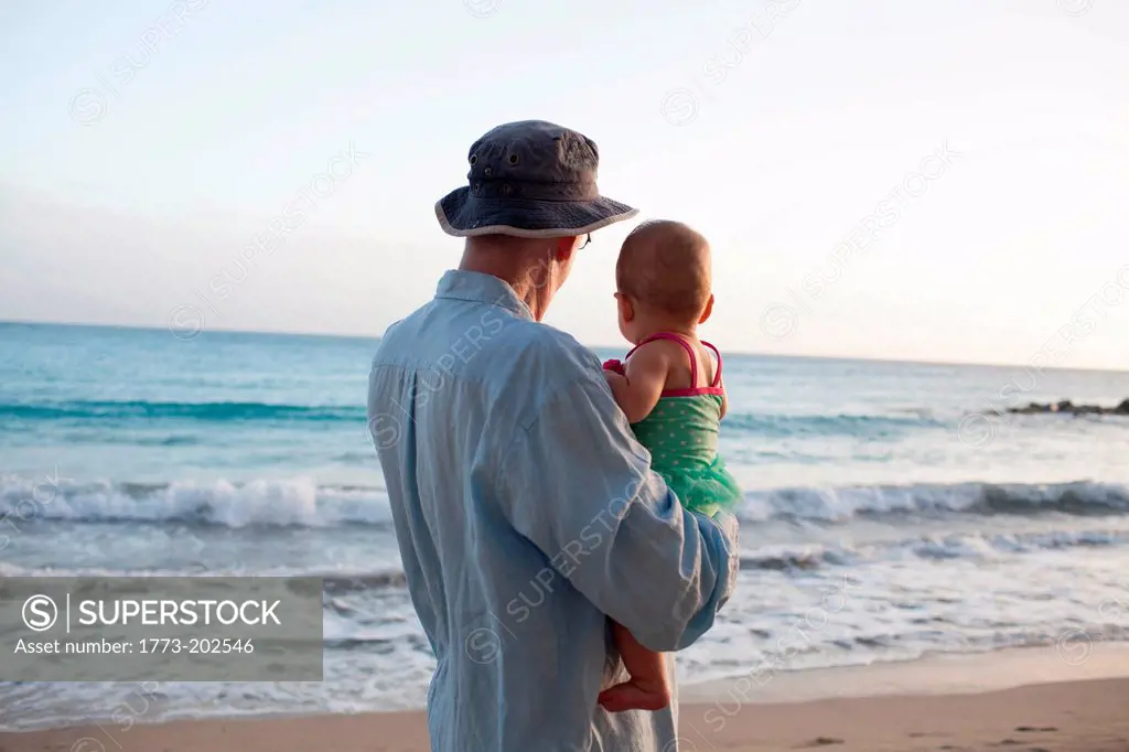 Grandfather with granddaughter on beach, St Maarten, Netherlands