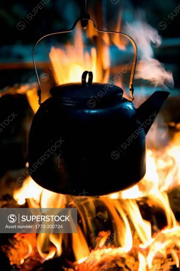 A kettle boils on top of a fire in a lavvu, a temporary home and tent of the Sami people, in Kirkeness, northern Norway