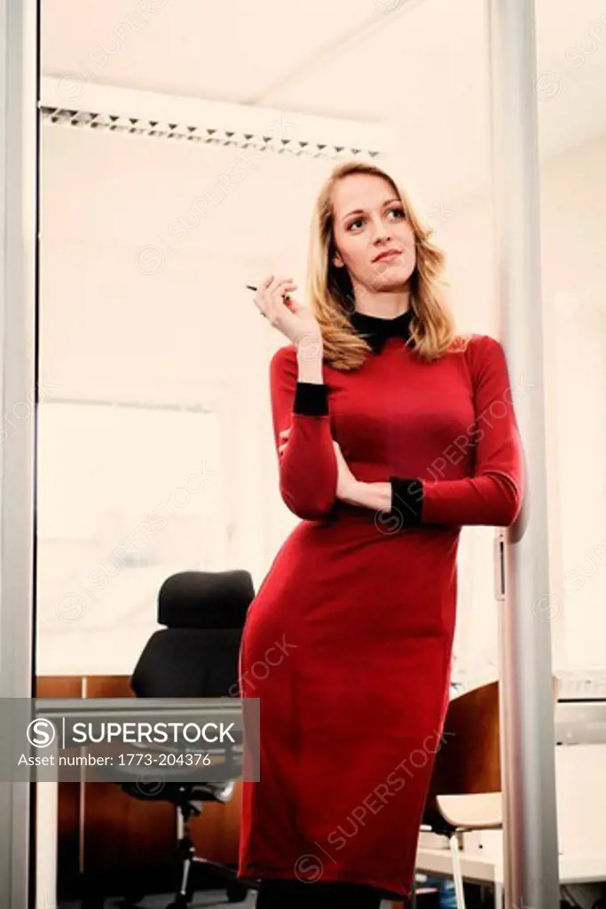 Woman in red dress on office doorway
