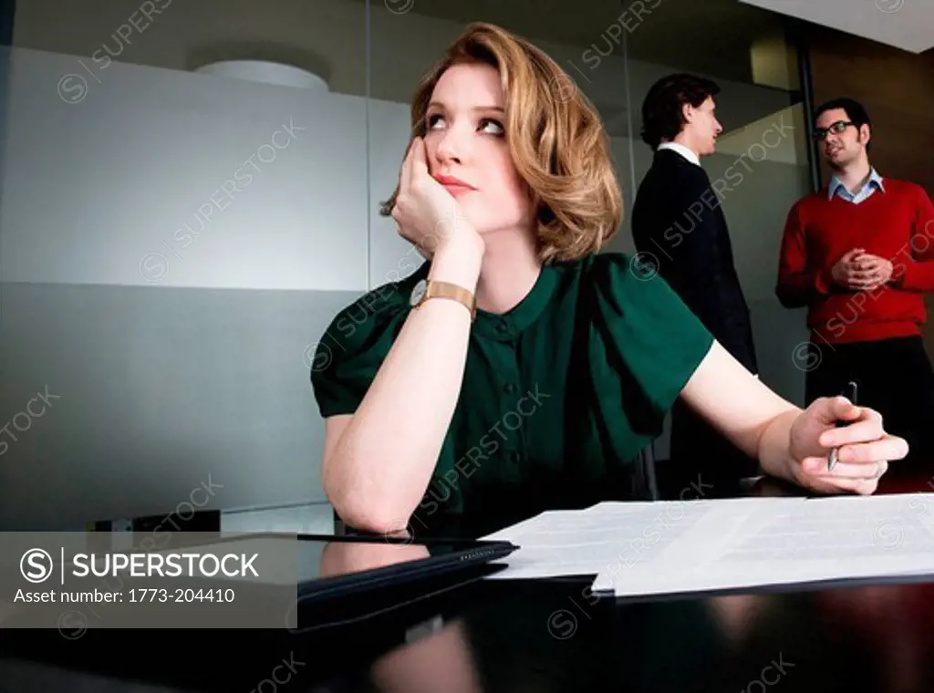 Woman in office, deep in thought