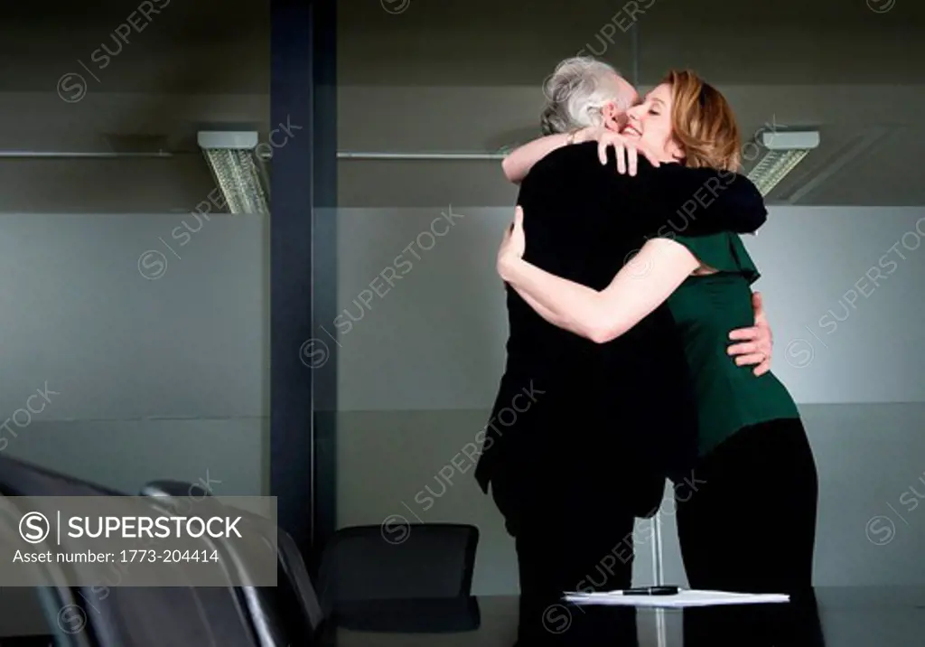 Businesspeople hugging