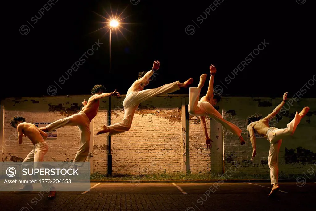 Multiple exposure of young male free jumping in car park
