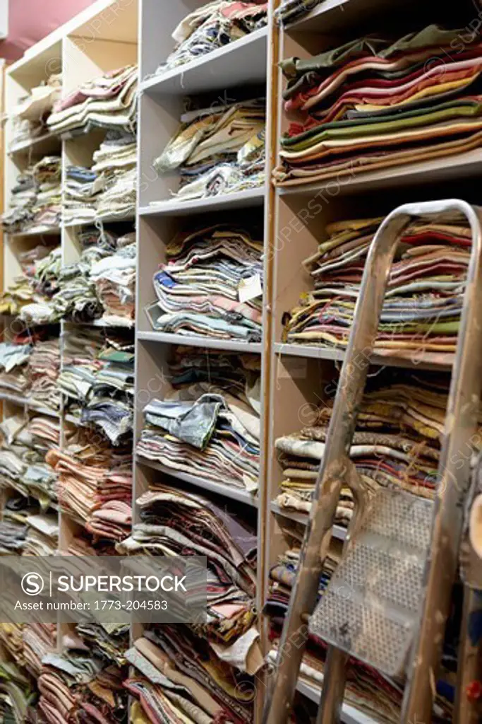 Fabric samples on shelves in textiles factory