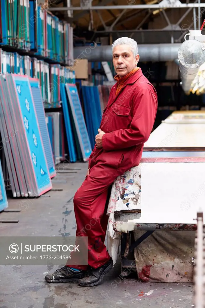 Portrait of man wearing boiler suit in screen printing factory