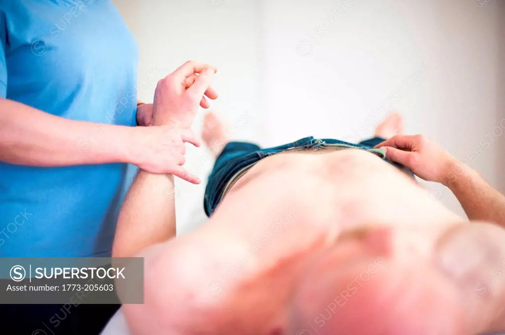 Woman checking man's pulse