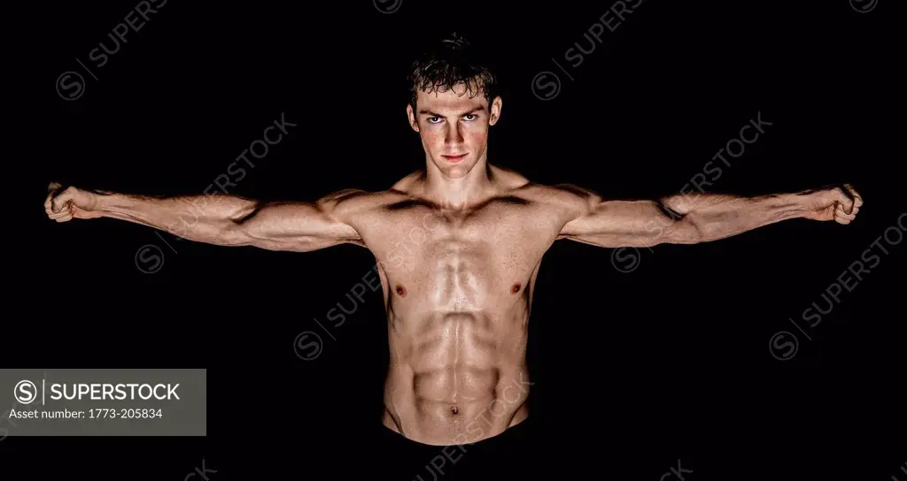 Body builder with outstretched arms showing off pectoral muscles