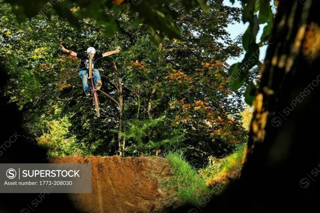 BMX rider mid air with arms outstretched