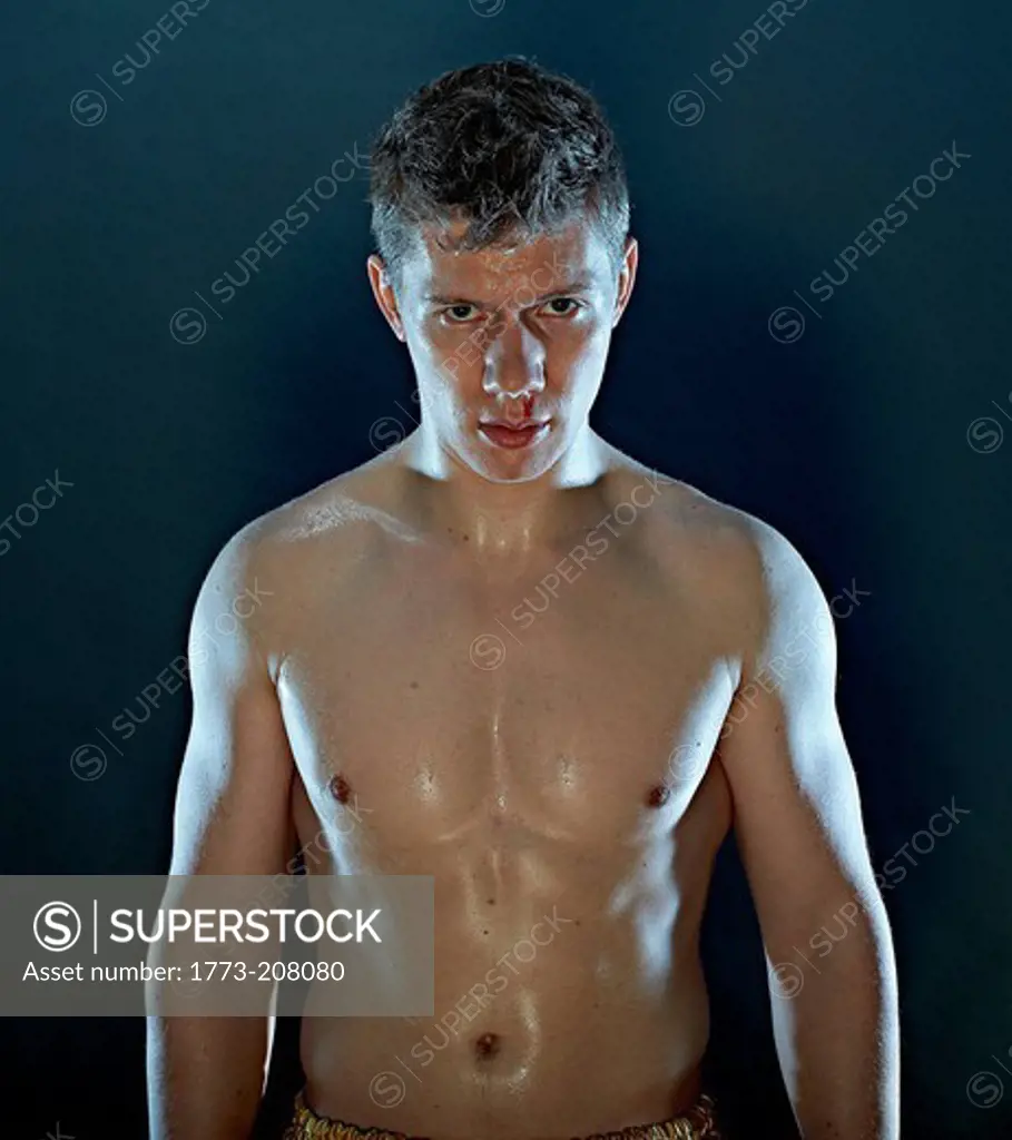 Portrait of young male boxer with bloody nose