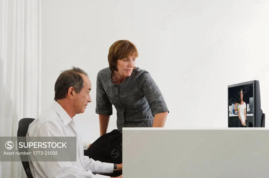 Work colleagues looking at computer