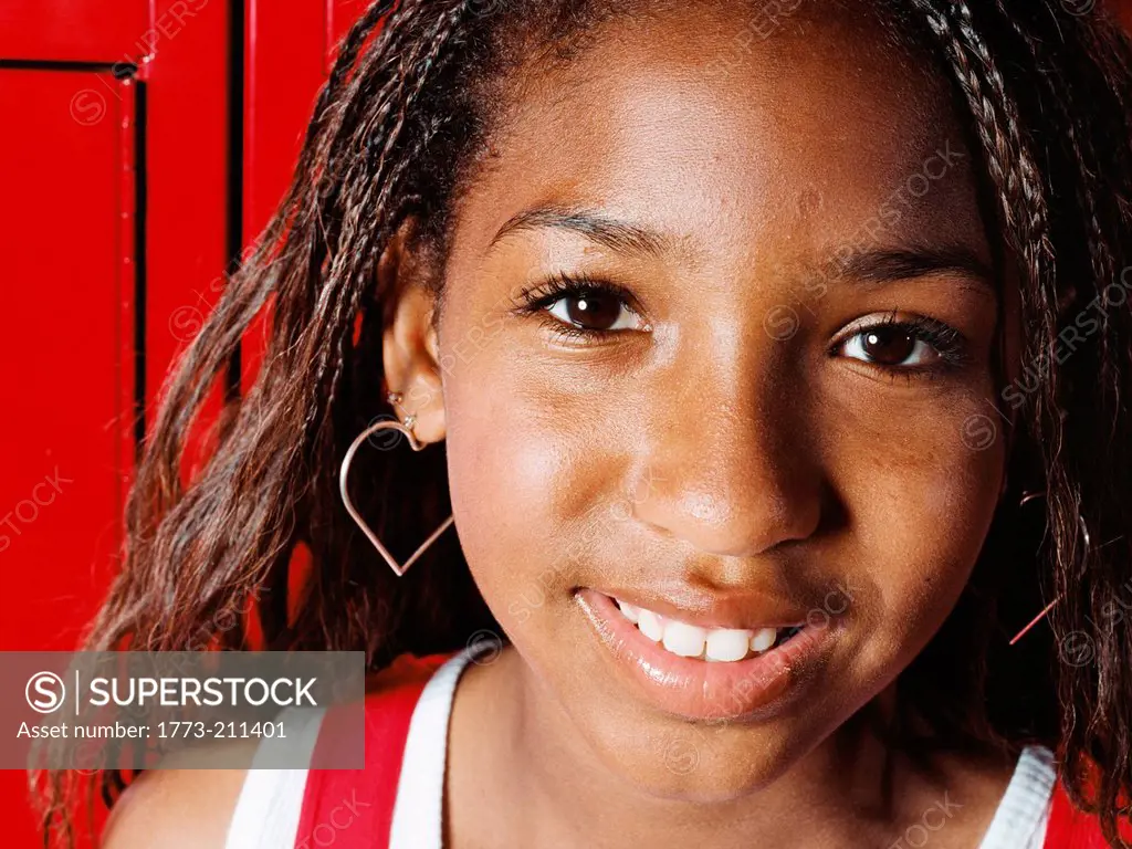 Girl smiling in school locker room, close up