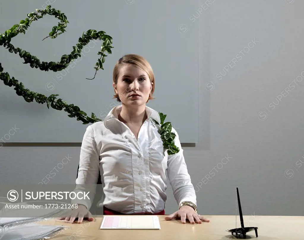 Woman by desk beeing attacked by plants