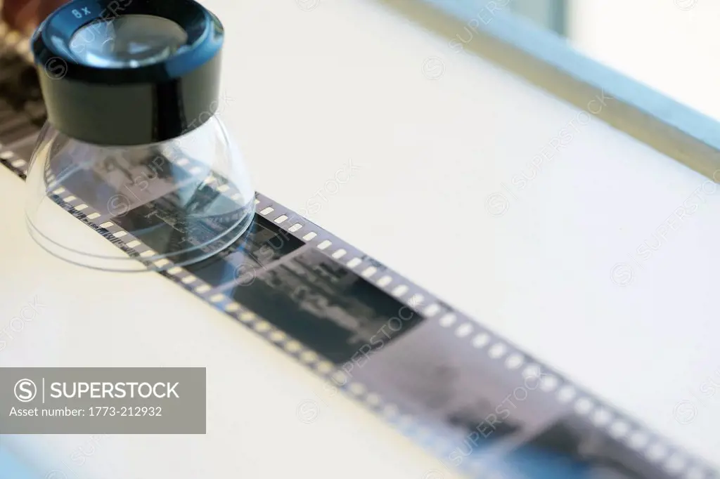 Strip of black and white negative film on lightbox