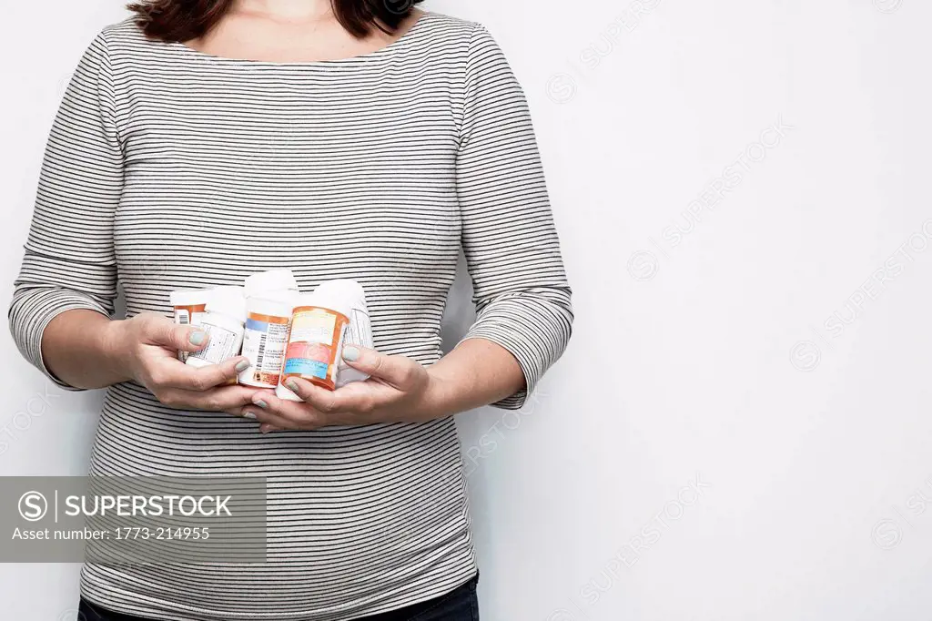 Pregnant woman holding medication