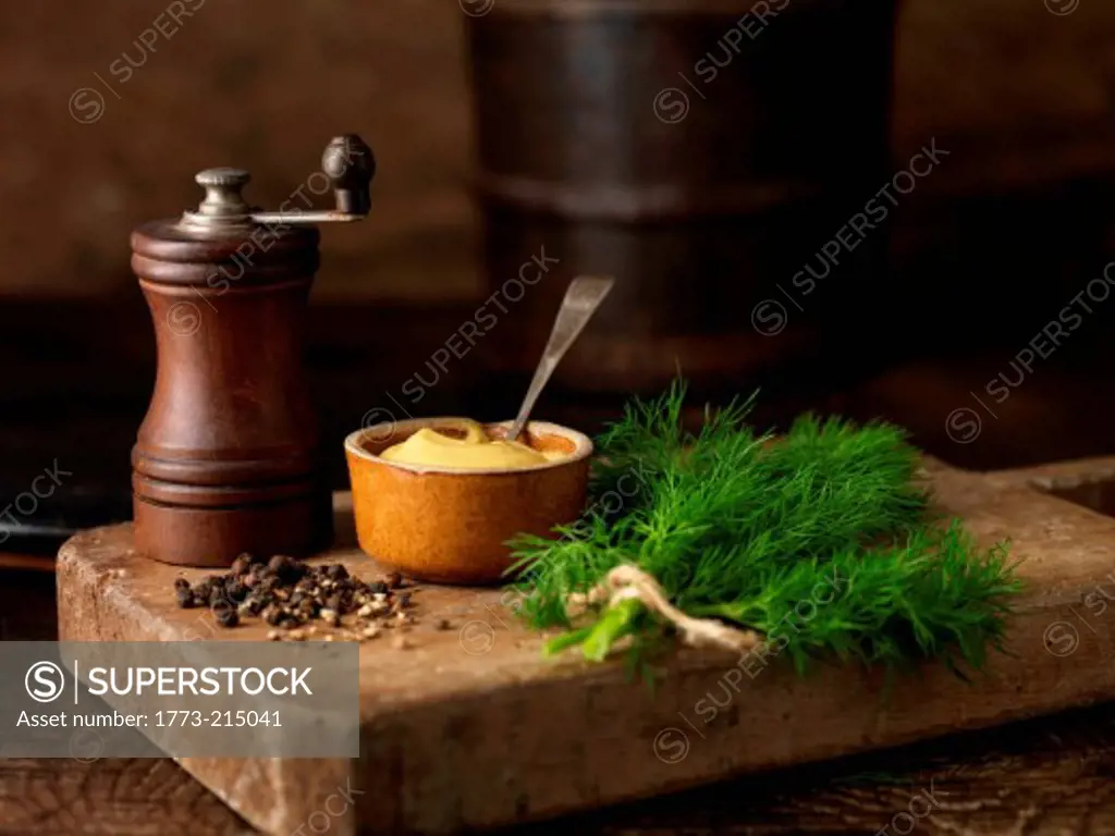 Still life with pepper grinder, dill and mustard (ingredients for lochmuir gravadlax)