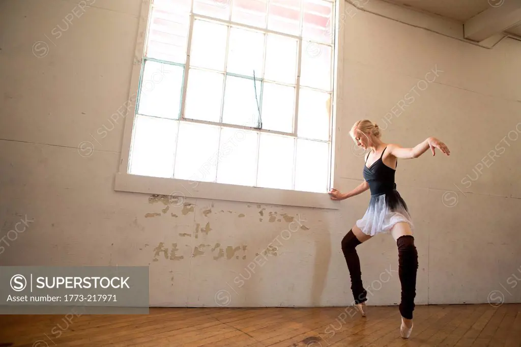 Ballet dancer on tip toes in studio