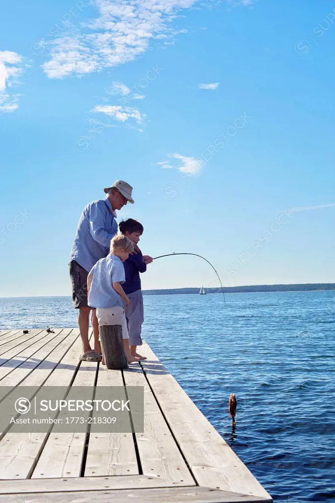 Grandfather and grandsons fishing, Utvalnas, Sweden