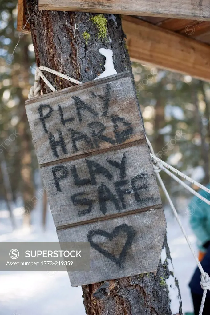 'Play hard, play safe' sign on tree