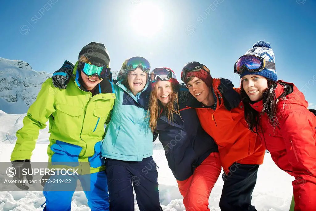 Friends wearing skiwear with arms around each other, Kuhtai, Austria