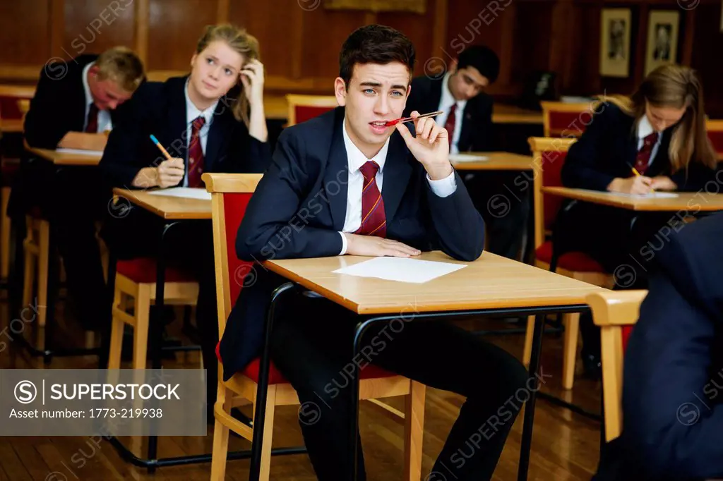 Group of teenage schoolchildren sitting examination