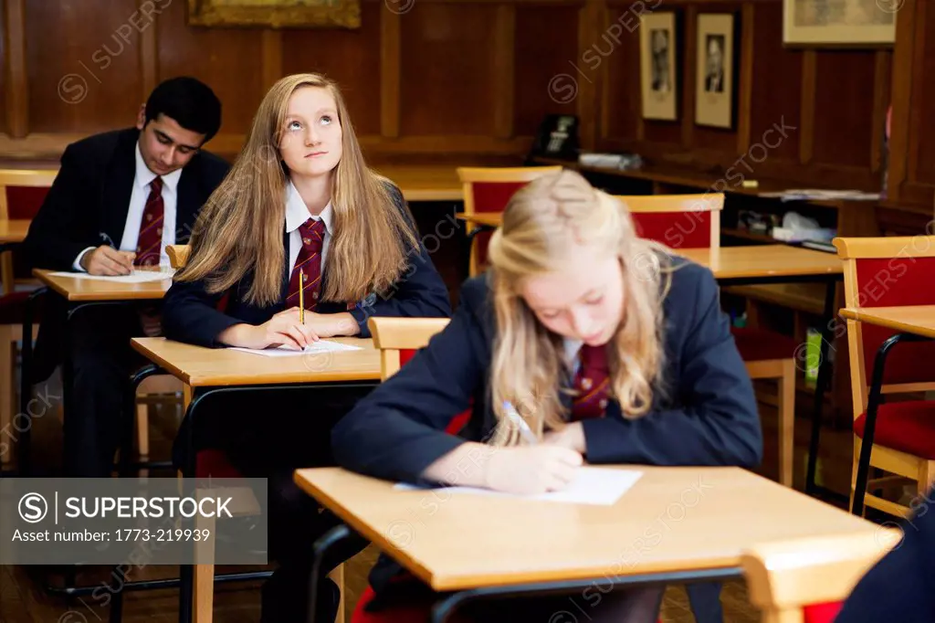 Group of teenage schoolchildren sitting exam