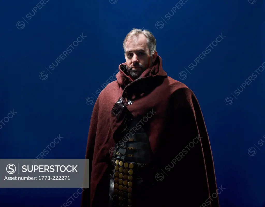 Studio portrait of gladiator wearing cloak