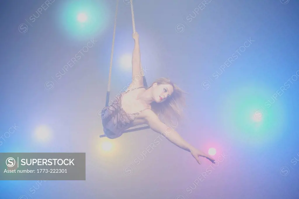 Young woman on trapeze