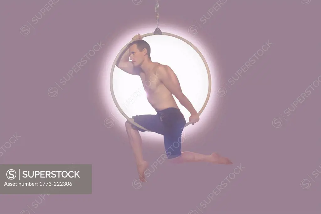 Male dancer balancing on hoop