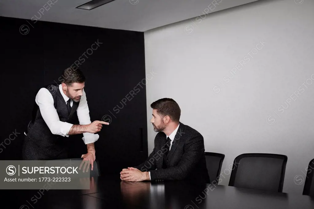 Manager pointing at employee, multiple image