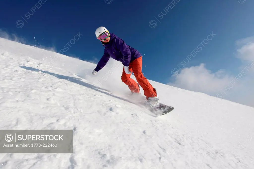 Snowboarder going down mountain