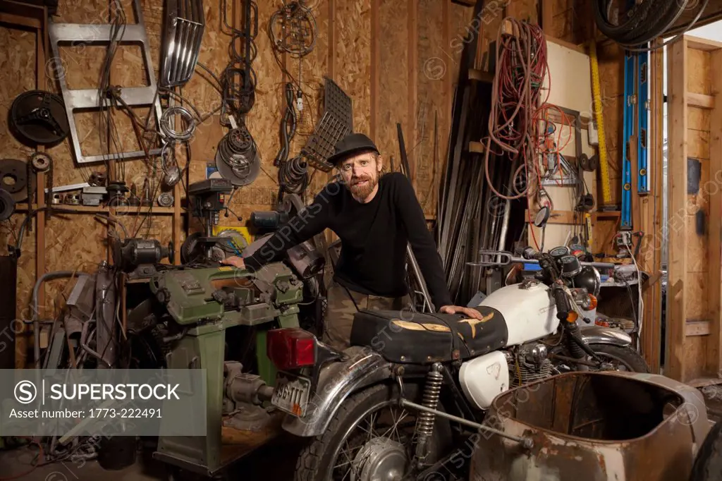 A metal artist and machine builder in his workshop