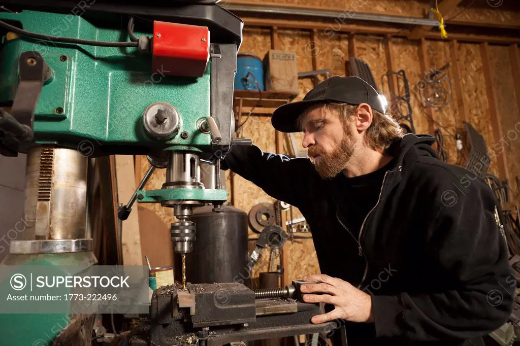 A metal artist and machine builder in his workshop