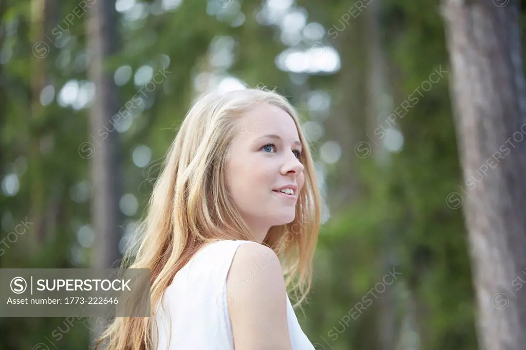 Portrait of teenage girl with long blonde hair looking away