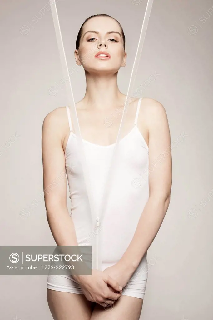 Woman posing behind zipper