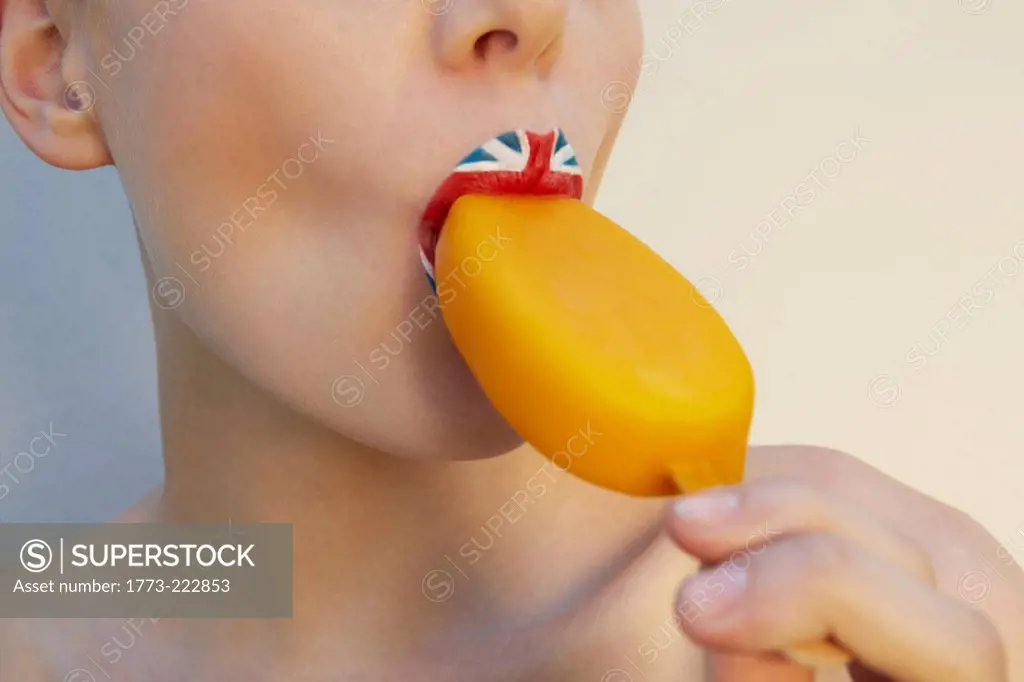 Studio shot of female with union jack lipstick eating ice lolly