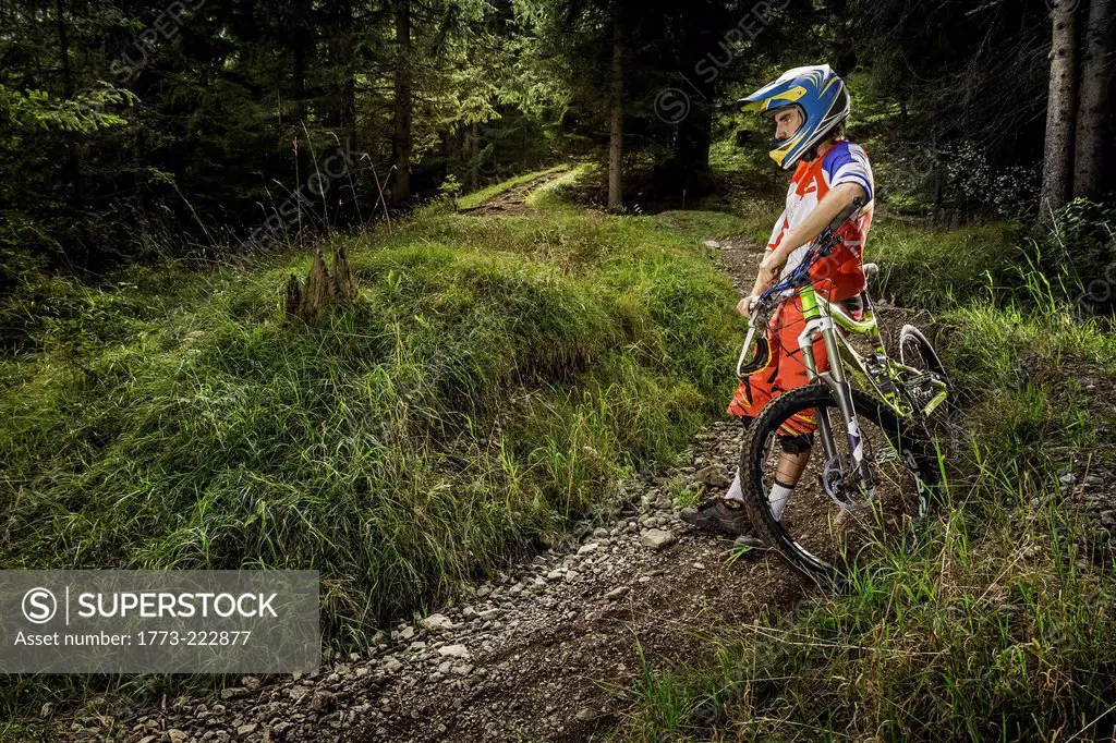 Young man leaning against mountain bike