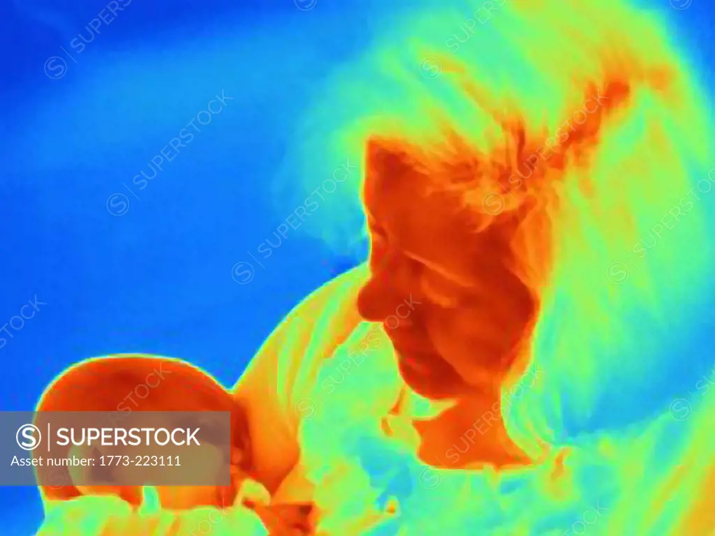 Thermal image of mother cradling six month baby boy