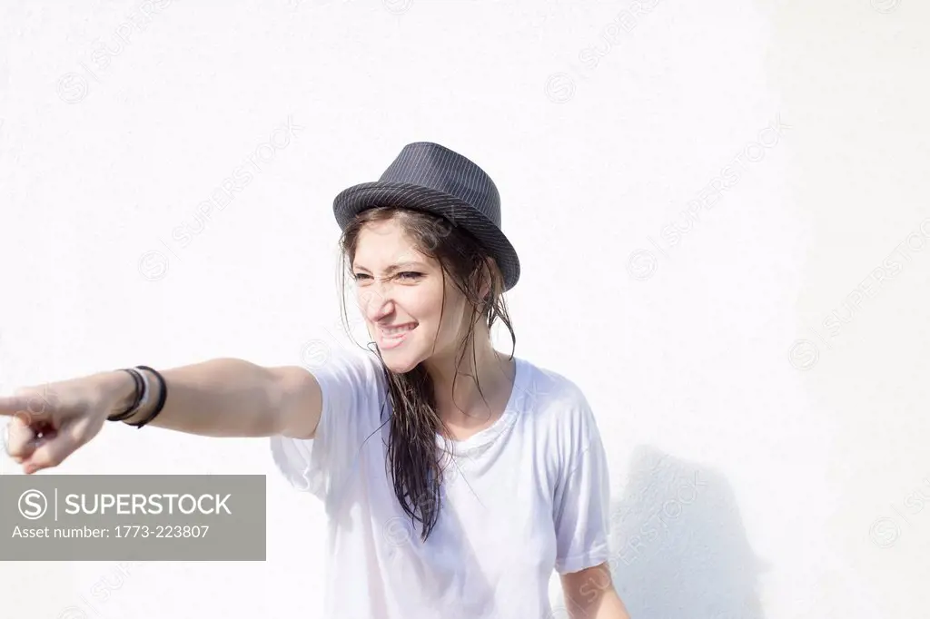 Young woman with attitude pointing finger