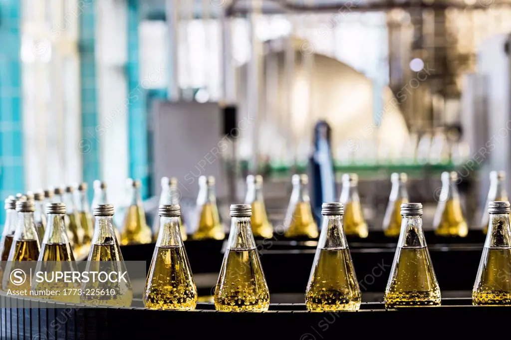 Bottles on conveyor belt in bottling plant
