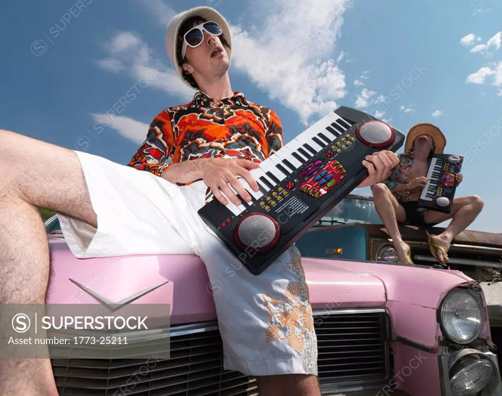 Musicians performing atop abandoned cars
