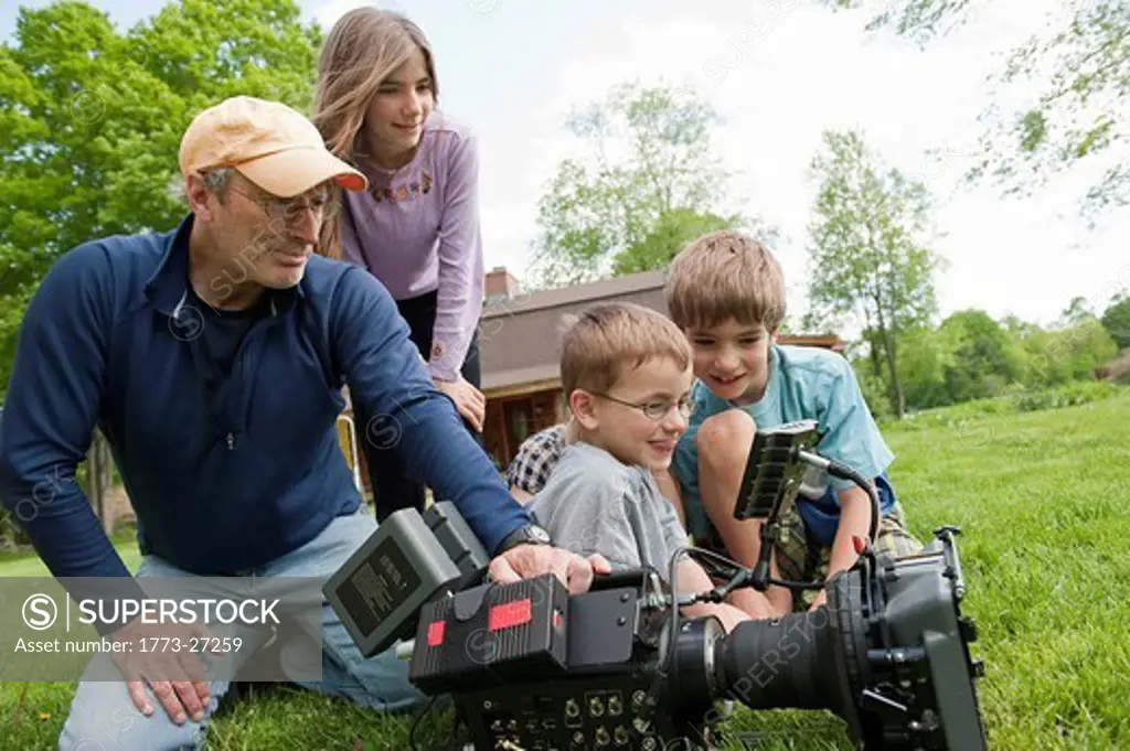 cinematographer demonstrating high definition Red camera to young children