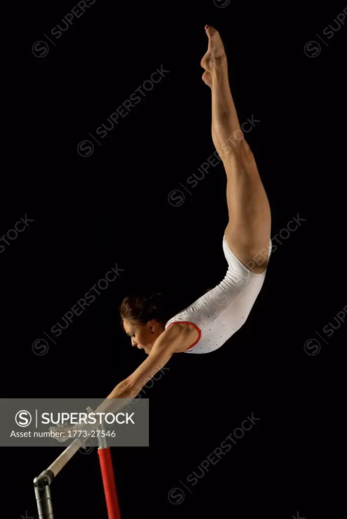 gymnast grabbing a bar mid flight