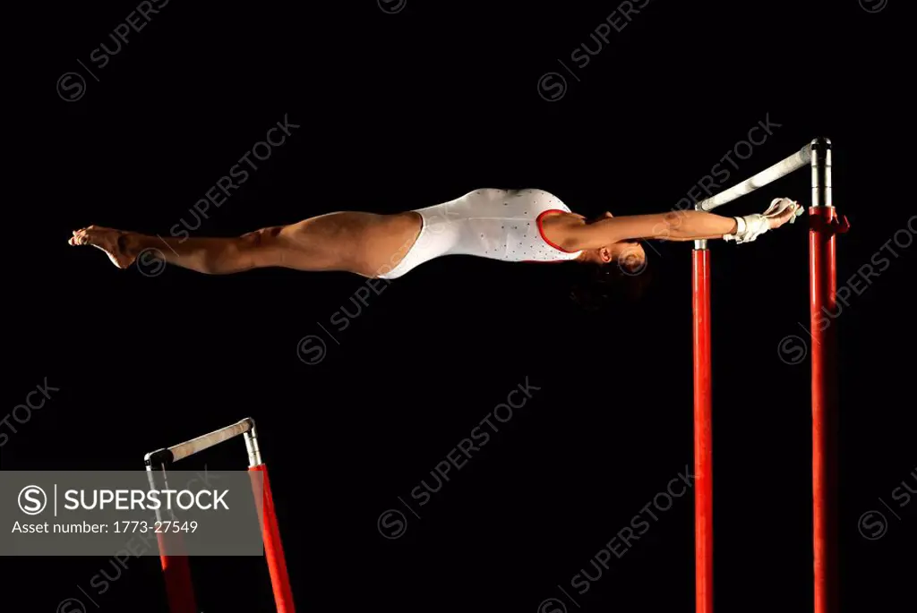 gymnast in between two high bars