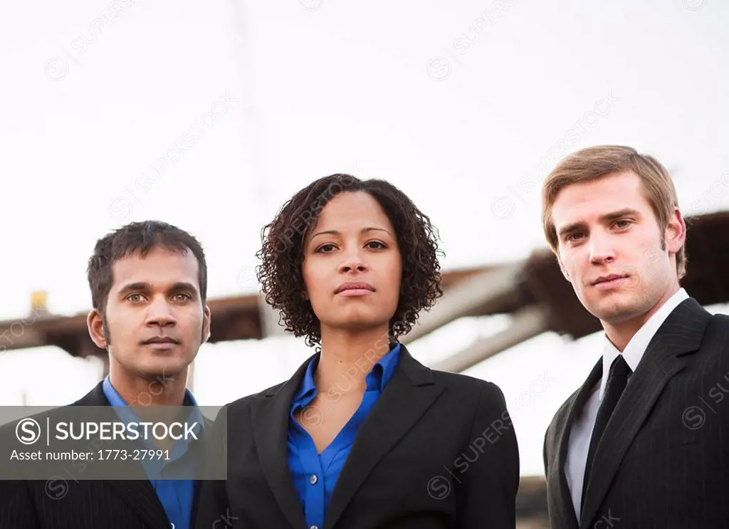 2 men and 1 woman in suits on worksite