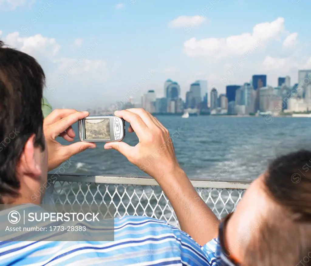 Man Taking picture of Cityscape