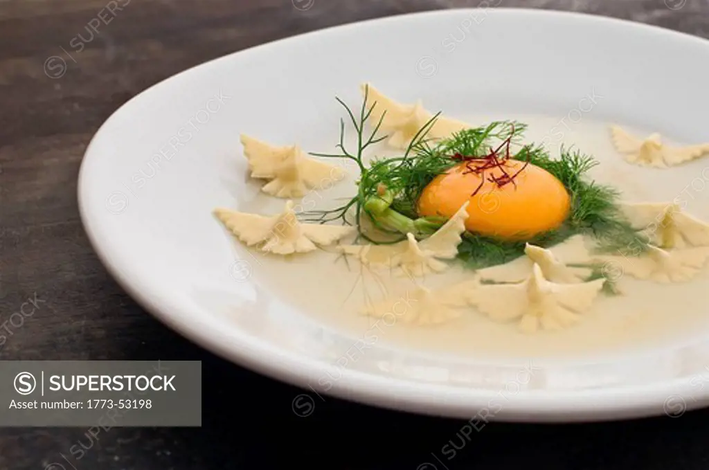 Close up of raw egg and pasta dish
