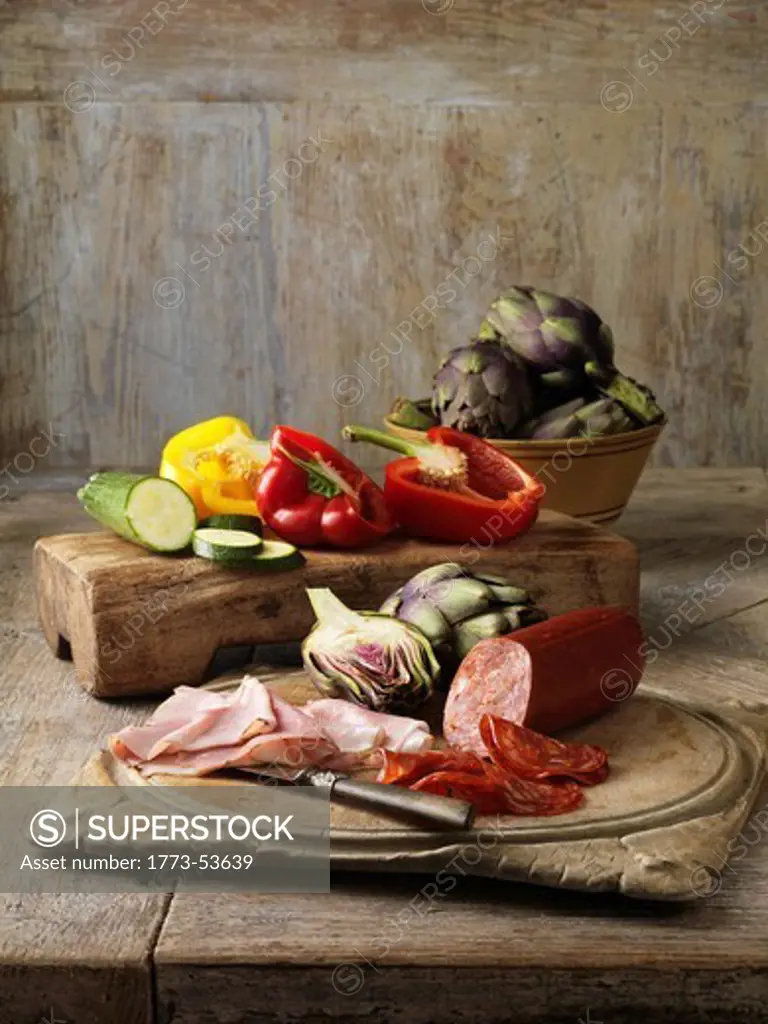 Artichokes/Red Peppers/Courgette/Ham & Salami on wooden board