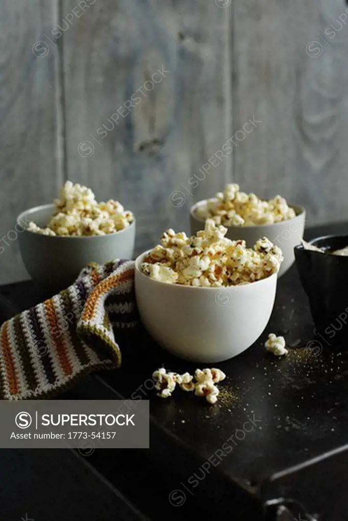 Bowls of flavored popcorn on table