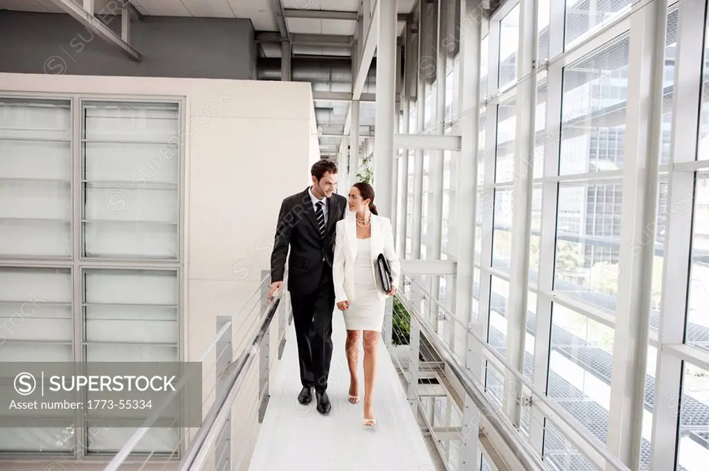 Business couple walking in corridor