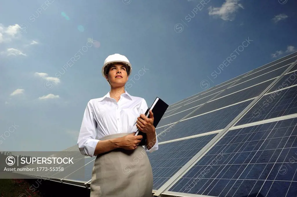 business woman in front of solar panel