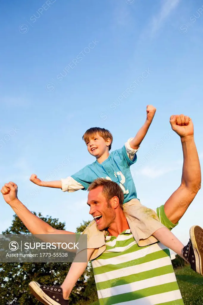 Father With Son on Shoulders Cheering